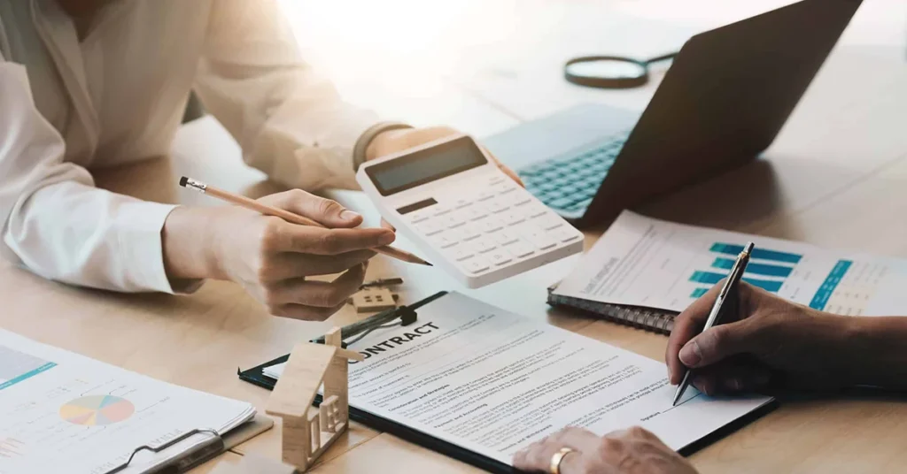 Property managers in a meeting with notepads and laptops