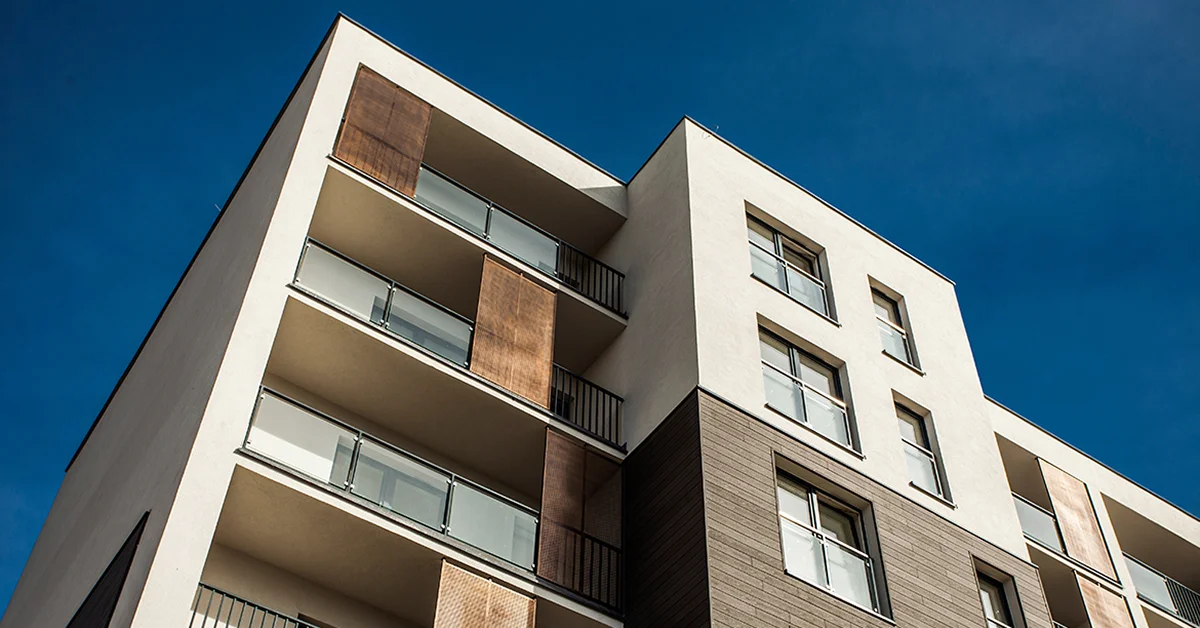 An image of a tower apartment block with a blue sky